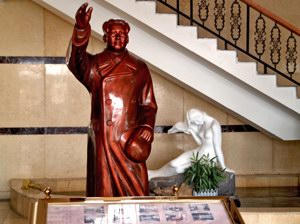 Mao The Great Helmsman and a languid mermaid in a hotel lobby